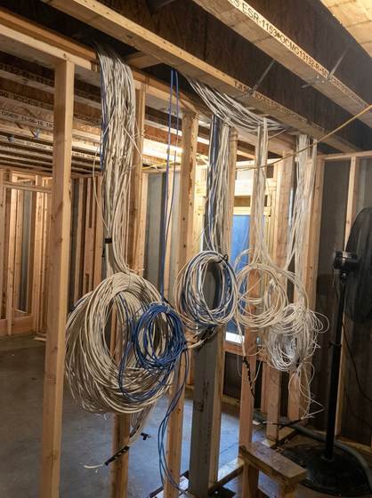 Structured wiring coiled and staged in a new build